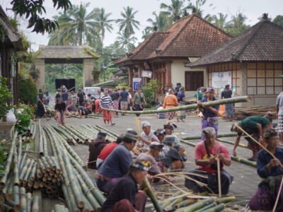 A preserved highland village street in Bali lined with plants and stone walkways.